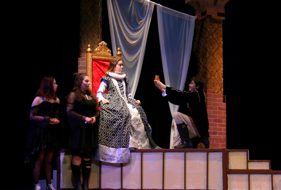 Ashley Benedict as Queen Elizabeth rehearses her scene with some of the cast members
