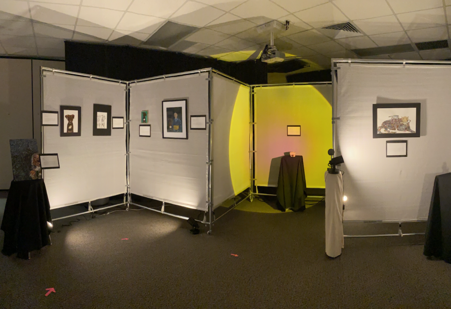 The IB art exhibition room included low lighting, tall walls and tapestries to hang the artists pieces. 