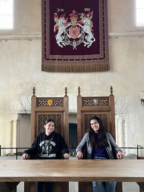 Ava James and Arabella Villaroel sit on the King and Queens thrones in Stirling Castle. These thrones are set in the castles party hall.