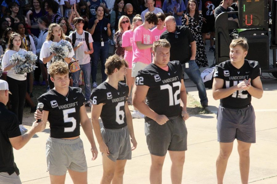 Football captains take the mic to inspire the pep rally crowd.