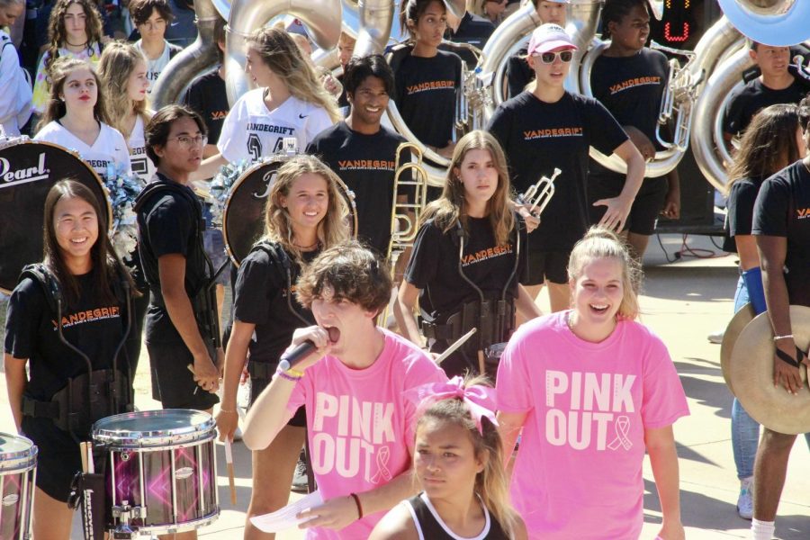 Student Section leader Jonah Sims and senior Mazie Heidger hype up the crowd with the bands drumline.