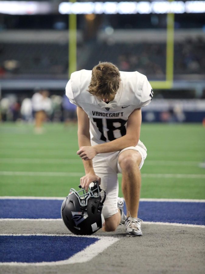 Kneeling in the Dallas Cowboys endzone before the game, players take a moment to reflect on the historic road to their last game.