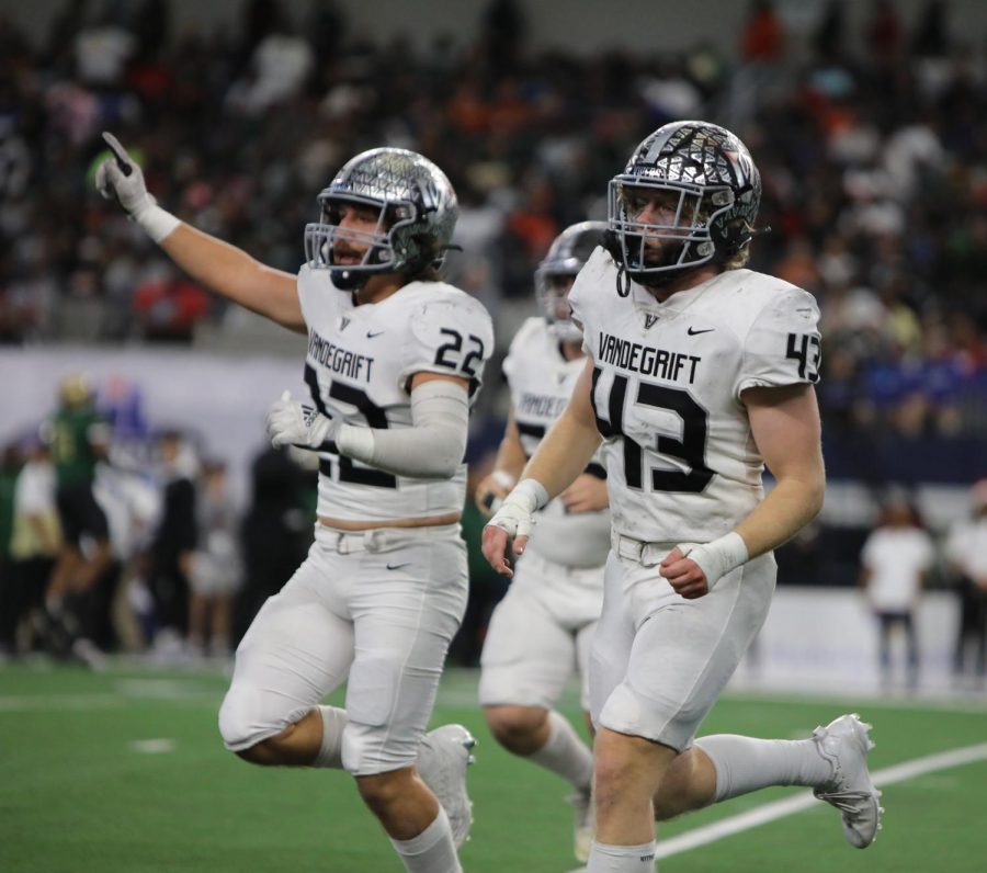 Senior defensive back Cruz Orta and junior linebacker Blaine Becker come to the sideline, celebrating a forced fumble and recovery in DeSoto's red zone.
