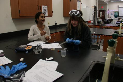 Students prepare to transfer bacteria in order to test for properties. 