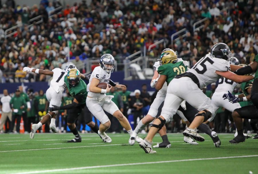 Taking the rush himself, senior quarterback Brayden Buchanan finds a hole in the DeSoto defense.