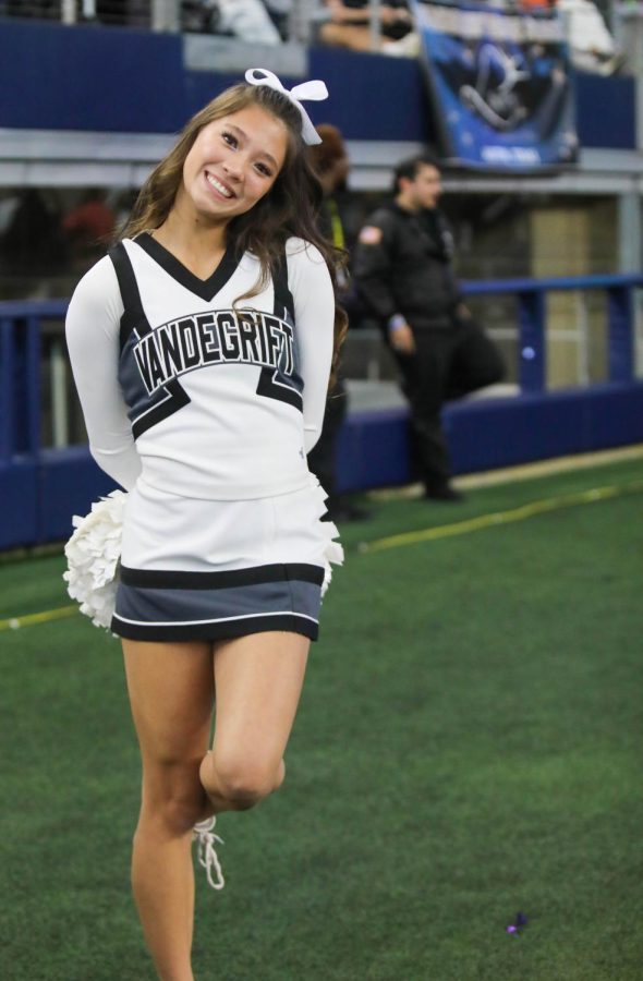 Junior cheerleader Katha Strenk notices the photographer.