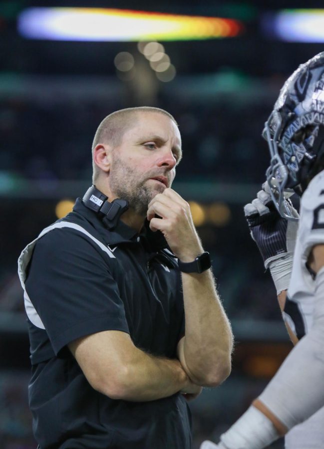 Head Coach Drew Sanders talks with senior Cruz Orta on how to better contain running back Deondra Riden of DeSoto. The championship offensive MVP rushed for a game-high 187 yards and three touchdowns.