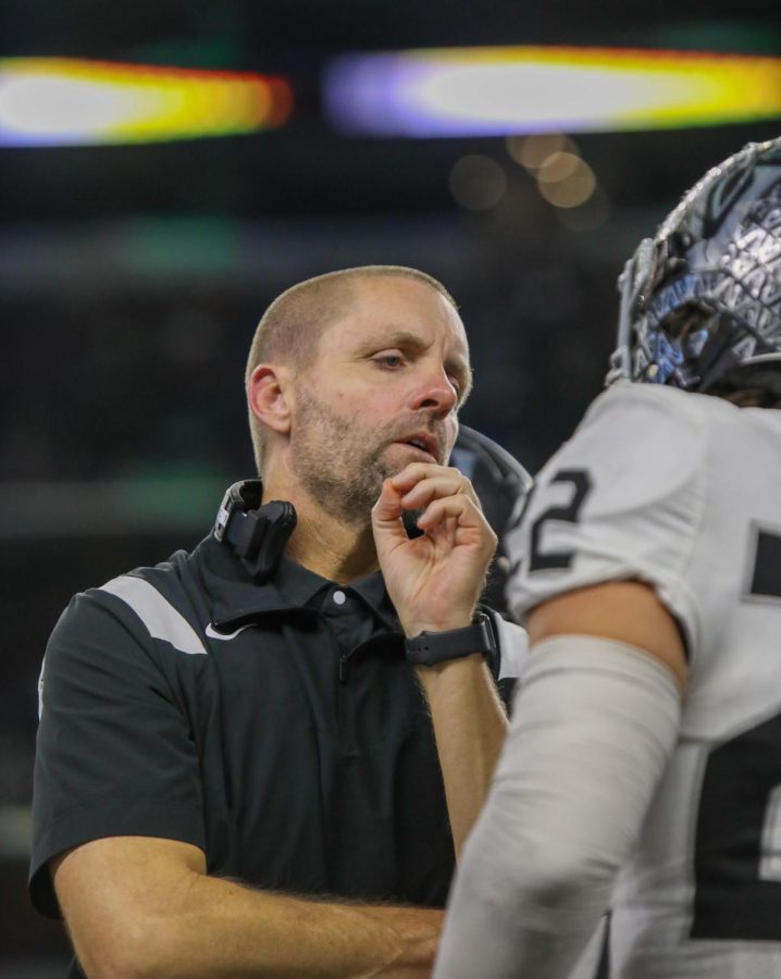 Head Coach Drew Sanders talks with senior Cruz Orta on how to better contain running back Deondra Riden of DeSoto. The championship offensive MVP rushed for a game-high 187 yards and three touchdowns.