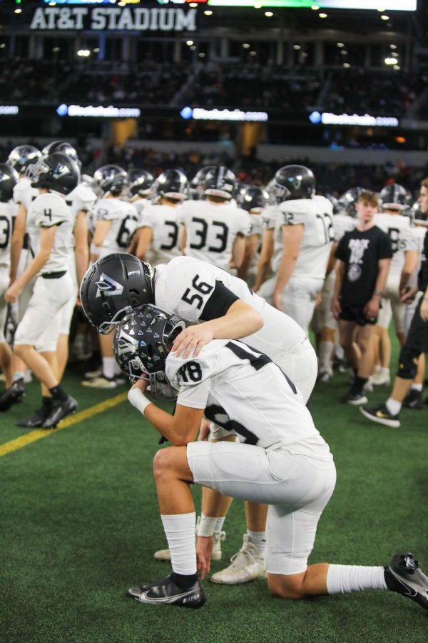 As the seconds tick off the clock, senior offensive lineman Braeden Gradwell consoles senior defensive back Jayden Harris.