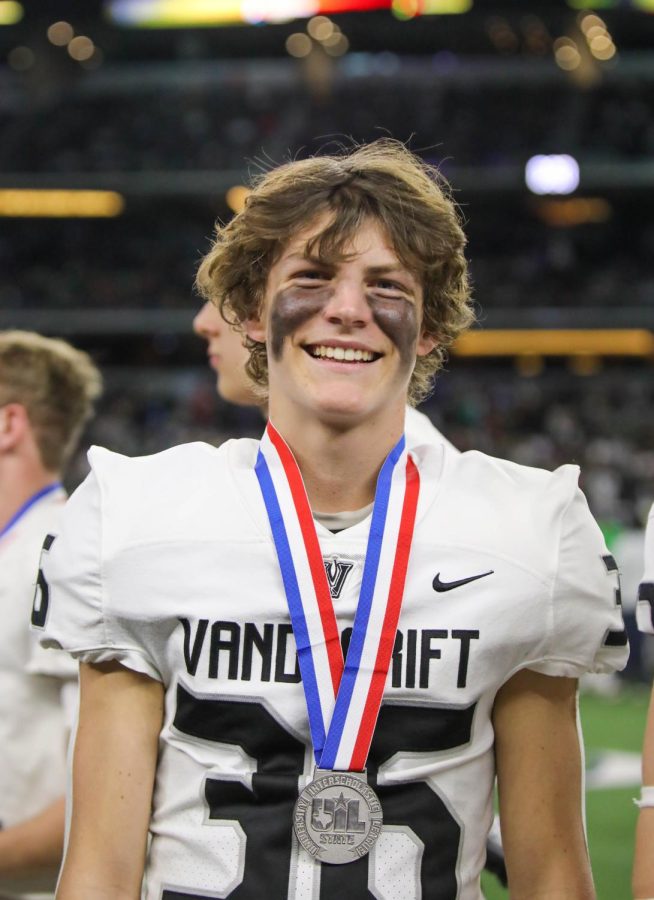 After receiving his medal, senior defensive back Preston Cooley is all smiles.