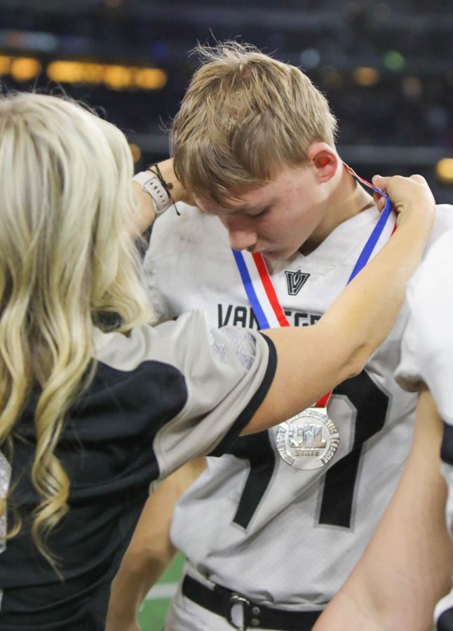 Pulled up to travel with varsity, sophomore Will Gates receives his silver medal from Assistant Principal Amanda Wilson. The APs and Principal Charlie Little handed out the awards.