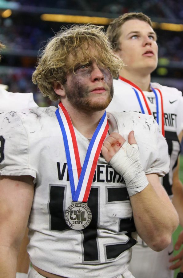 Showing the toll of the game, junior linebacker Blaine Becker looks to the fans in a last round of applause for the teams accomplishment in making the state championship and their efforts on the field at AT&T Stadium.