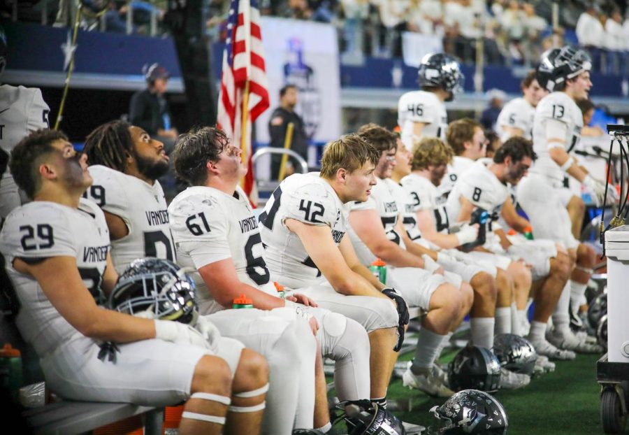 Dejected as DeSoto pulls away, senior defensive lineman Oliver Yndo sits with his team as they watch the offense take the field one last time.