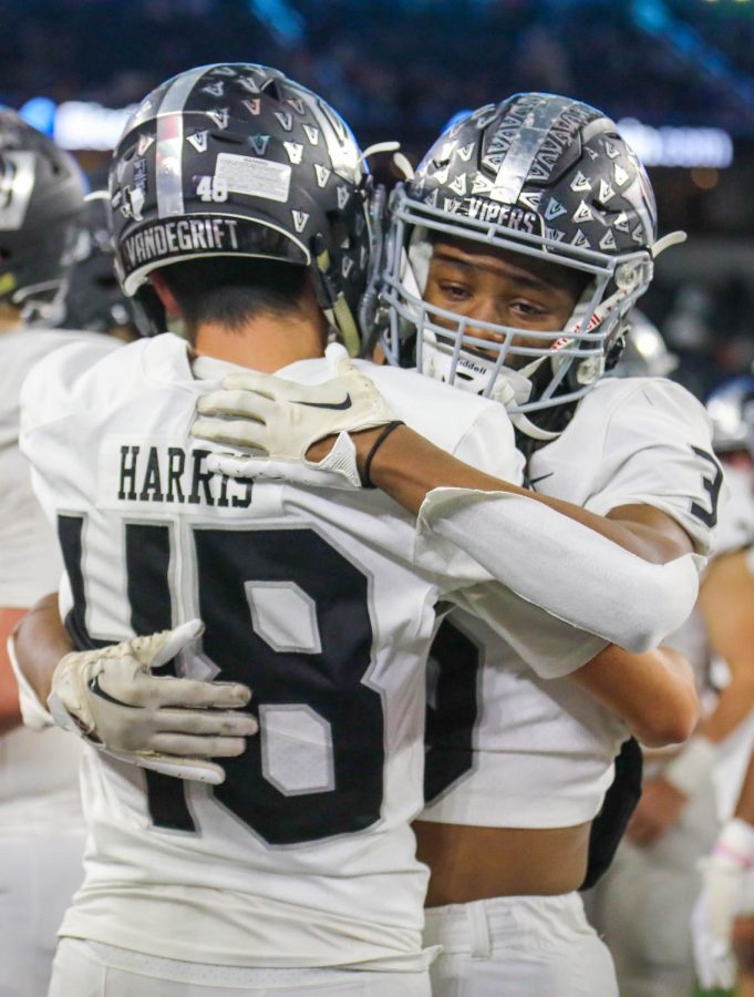 Post game, senior wide receiver RayJean Middleton embraces senior defensive back Jayden Harris.