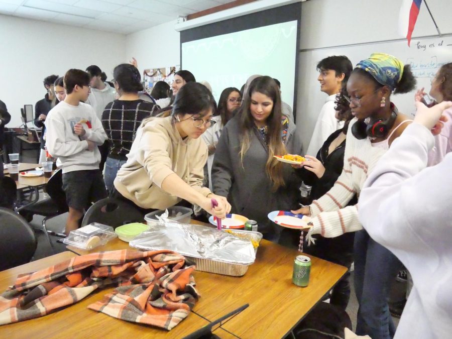 Students serve and eat homemade biriyani during the potluck. 