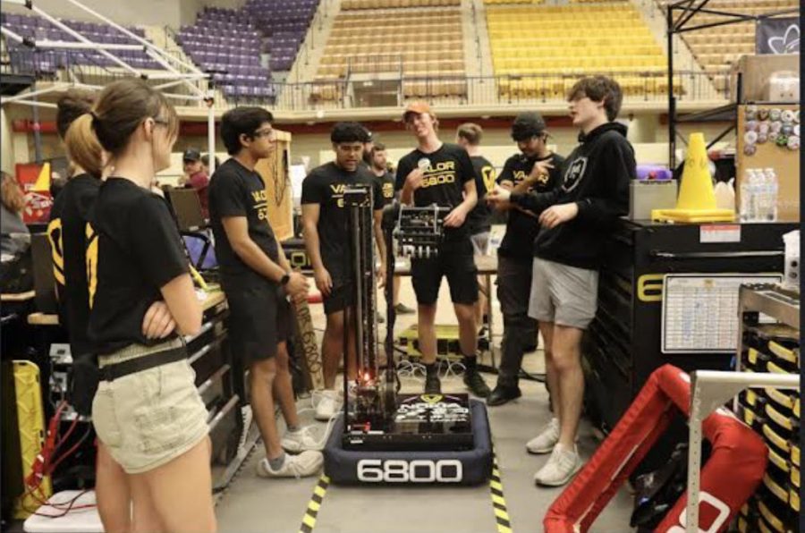 Pit+Crew+works+on+robot+and+adjusts+in+between+rounds+of+competition.+They+work+on+building+the+robots.