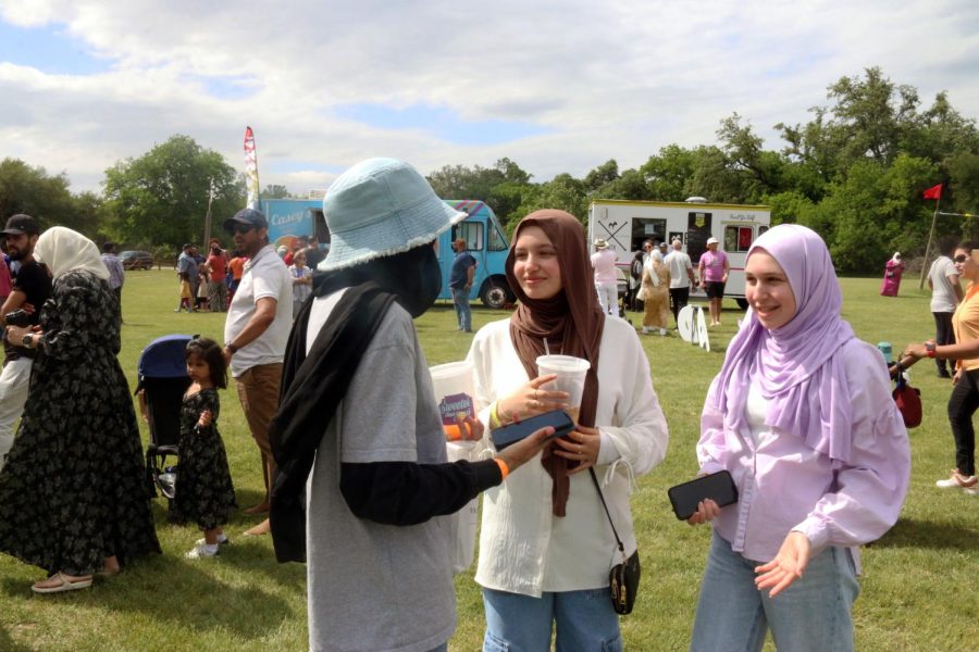 Sophomores Myreen Malik, Layali Hasan and Dana Zohny converse while waiting in a long line for Asian Express, a popular Chinese food truck catering the carnival.
