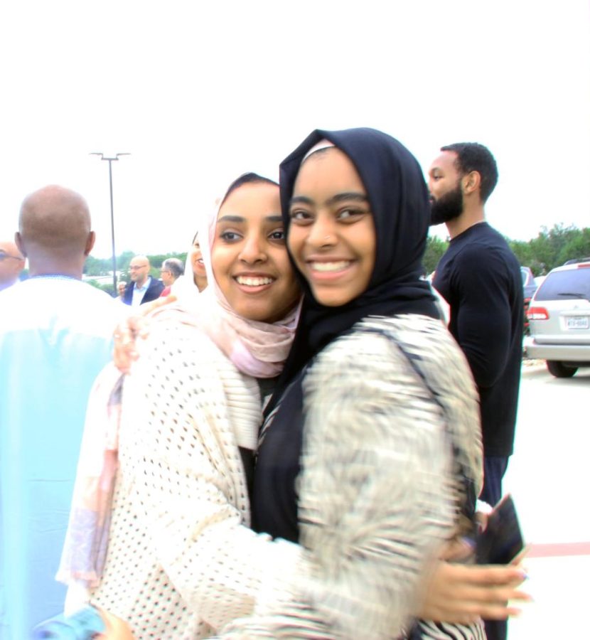 Sophomore Tala Mahjoub embraces junior Afnan Gabir, a classic and affectionate greeting seen often during Eid.