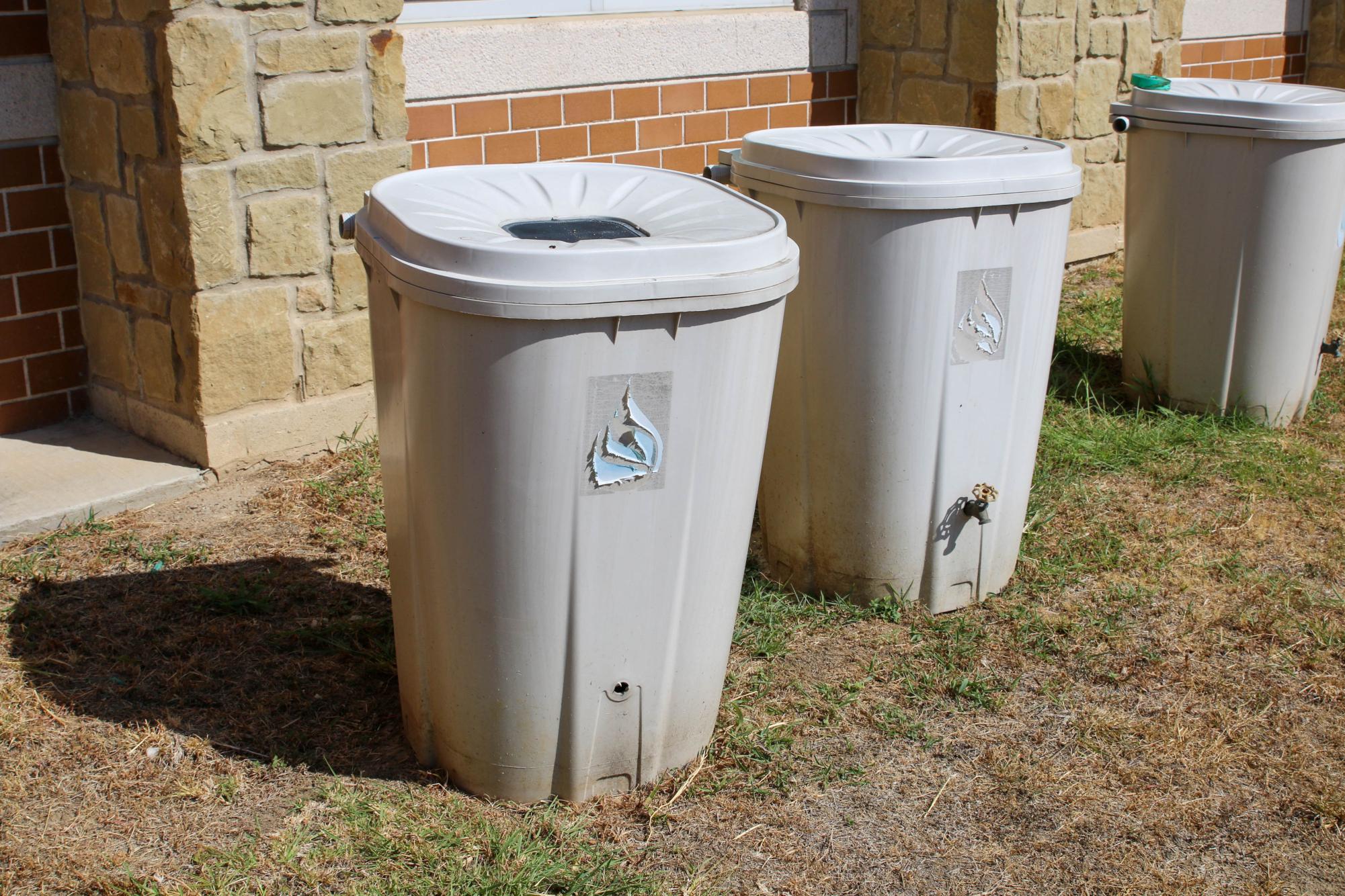 Rain collection barrels left over from a past school garden lie near the first building. The garden remains unattended as of 2023. 