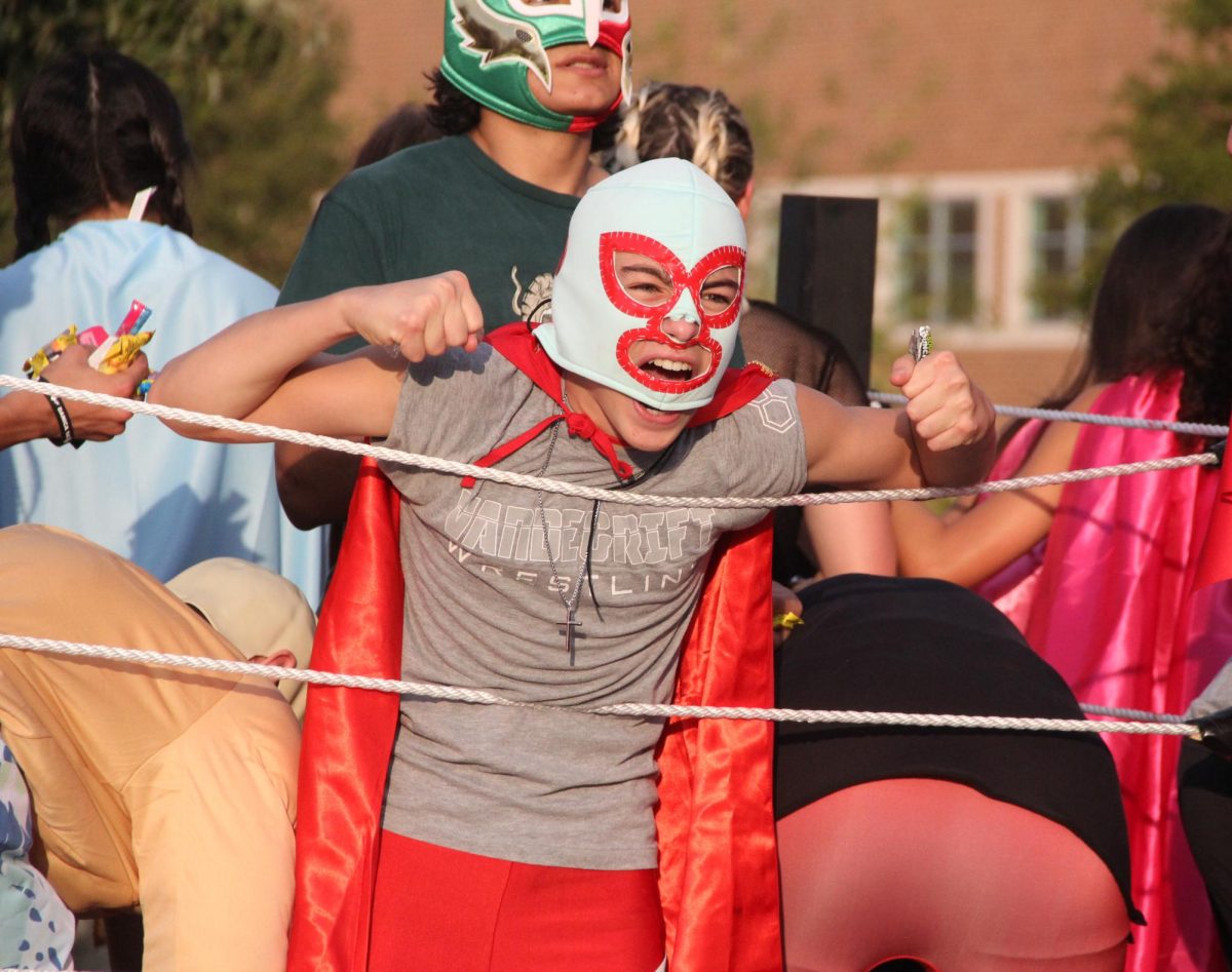 The wrestling float plays up the WWE sides of their personalities while throwing out candy at the Homecoming parade on Wednesday, Sept. 27. 