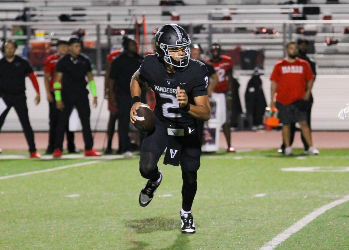 Scrambling, senior quarterback Deuce Adams looks for options against Manor on Friday, Sept. 29. The Vipers won 51-6.