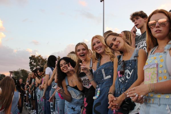 Decked out in denim, senior girls show their viper spirit at the September 29 Homecoming game. It is a Viper tradition to wear customized overalls to the games. 
