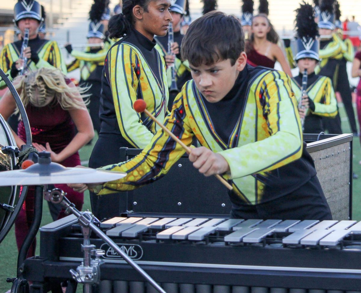 Vision performs with band during the pre-game for Homecoming Friday.