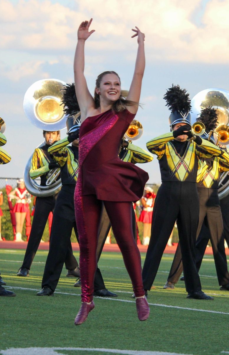 Vision performs with band during the pre-game for Homecoming Friday.