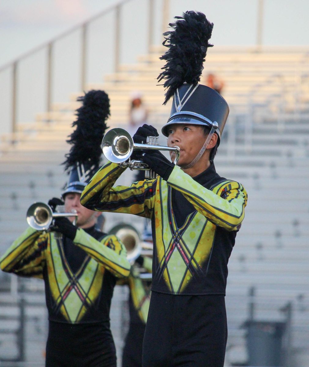 Vision performs with band during the pre-game for Homecoming Friday.