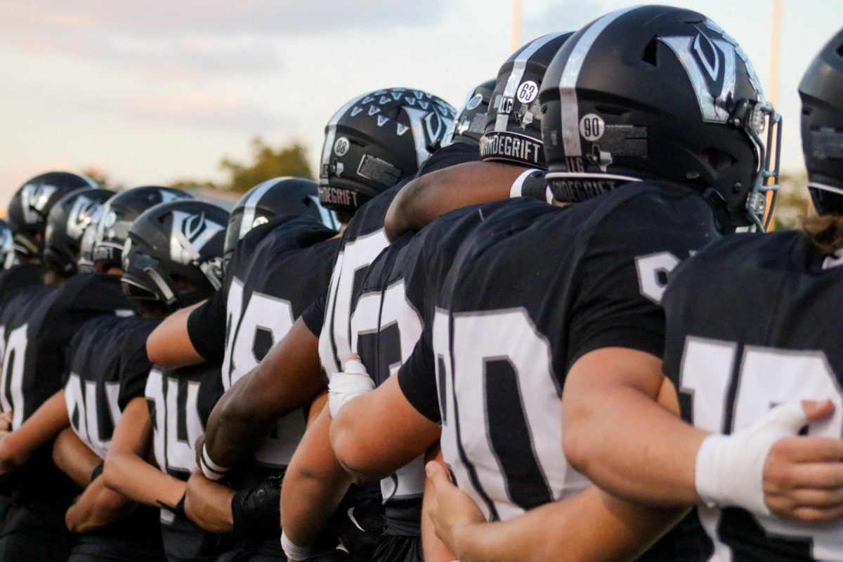 The varsity football team prepares to take the field against Manor for Homecoming on Sept. 29. The team won 51-6 to remain undefeated at 5-0.