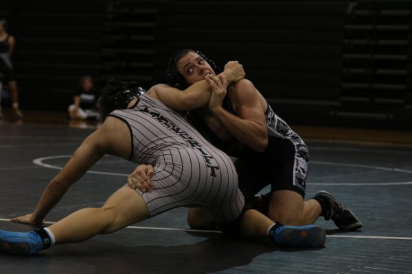 Taking on junior Ryan Lim, sophomore Bryce Hampton wrestles him off during the Nov. 9 scrimmages. 