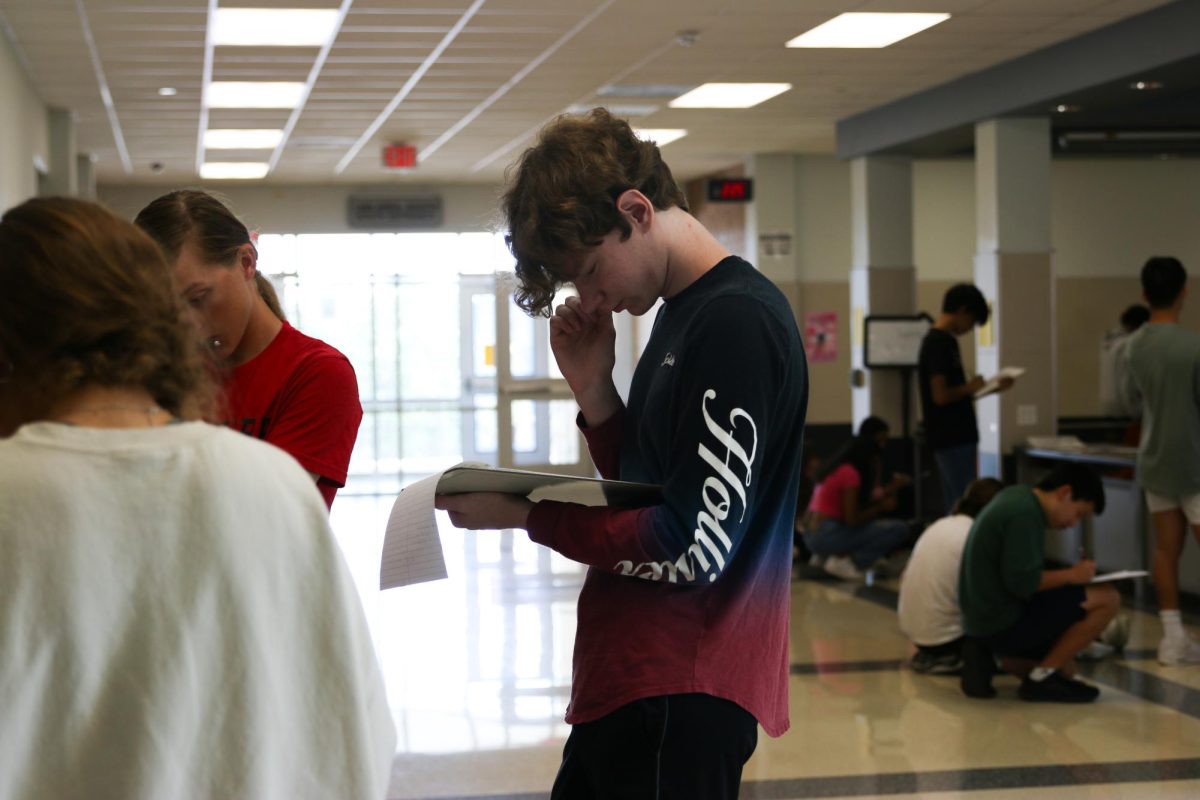 A student thinks through his answers while completing a walk around activity in calculus BC. Through completion of the activity, students could spell Love Calculus, with the problems.