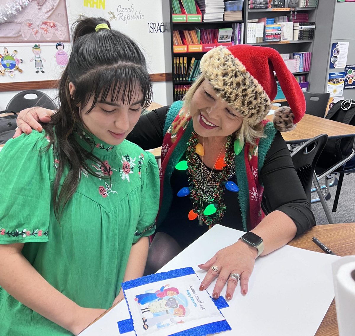 Medineh Nasir, who is from Afghanistan, starts her project for the ESL Celebration Around The World alongside teacher Mima Nazarene. She presented about the celebrations for Adha Eid from her country. 