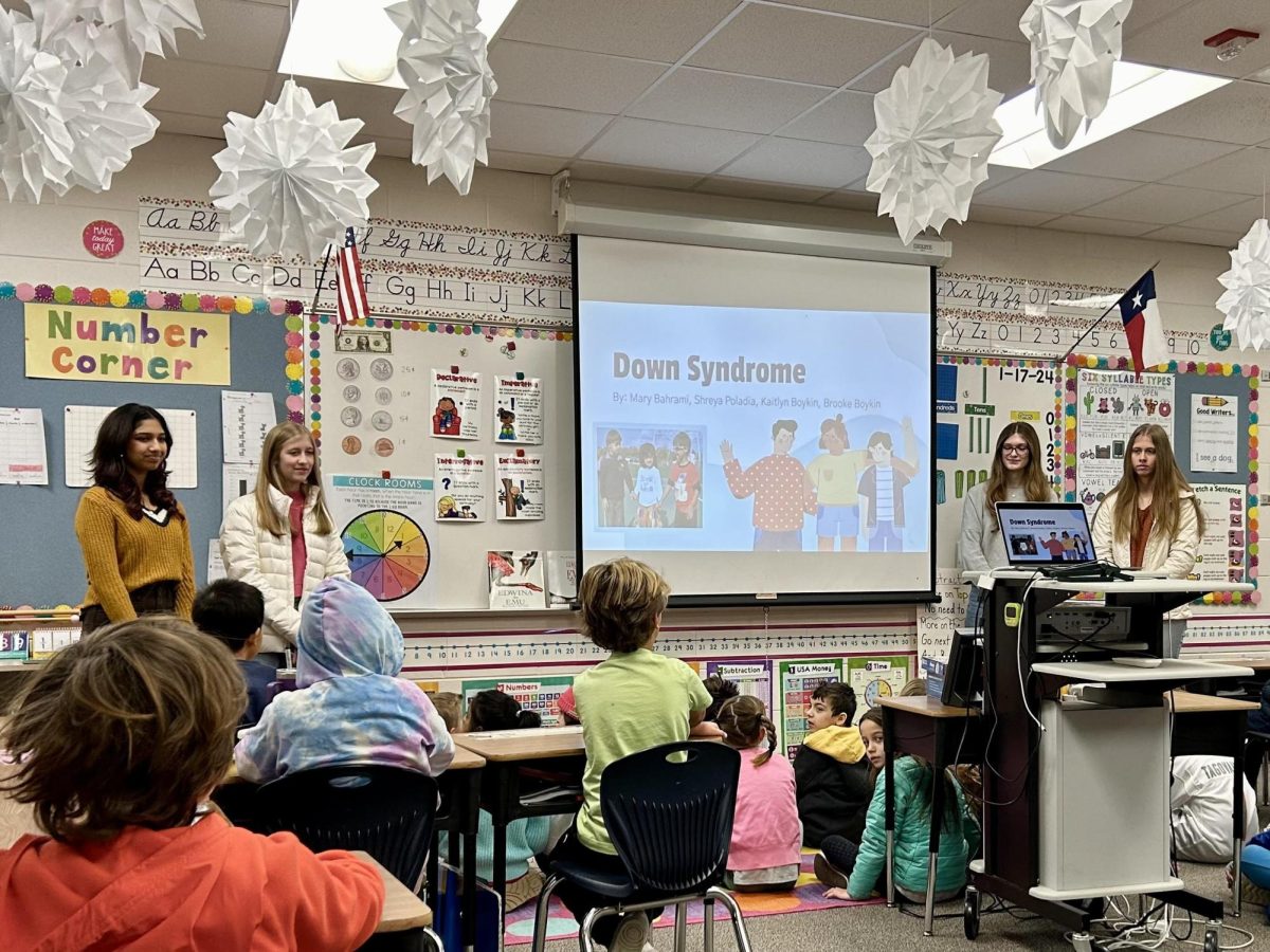 Sophomore Shreya Poladia, and juniors Mary Bahrami, Brooke Boykin, and Kaitlyn Boykin read Kenny Kicks Back to the second grade class at River Ridge Elementary on Jan. 17. 