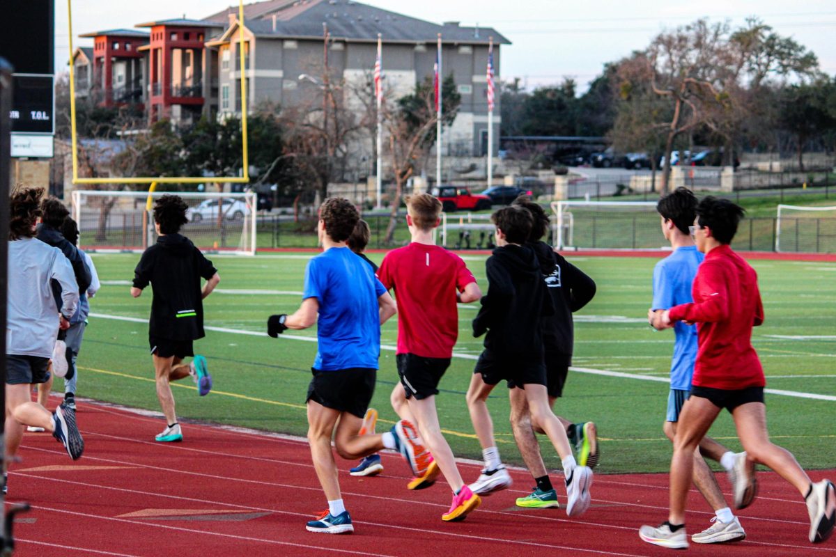 The cross-country team doing their morning run as a group.