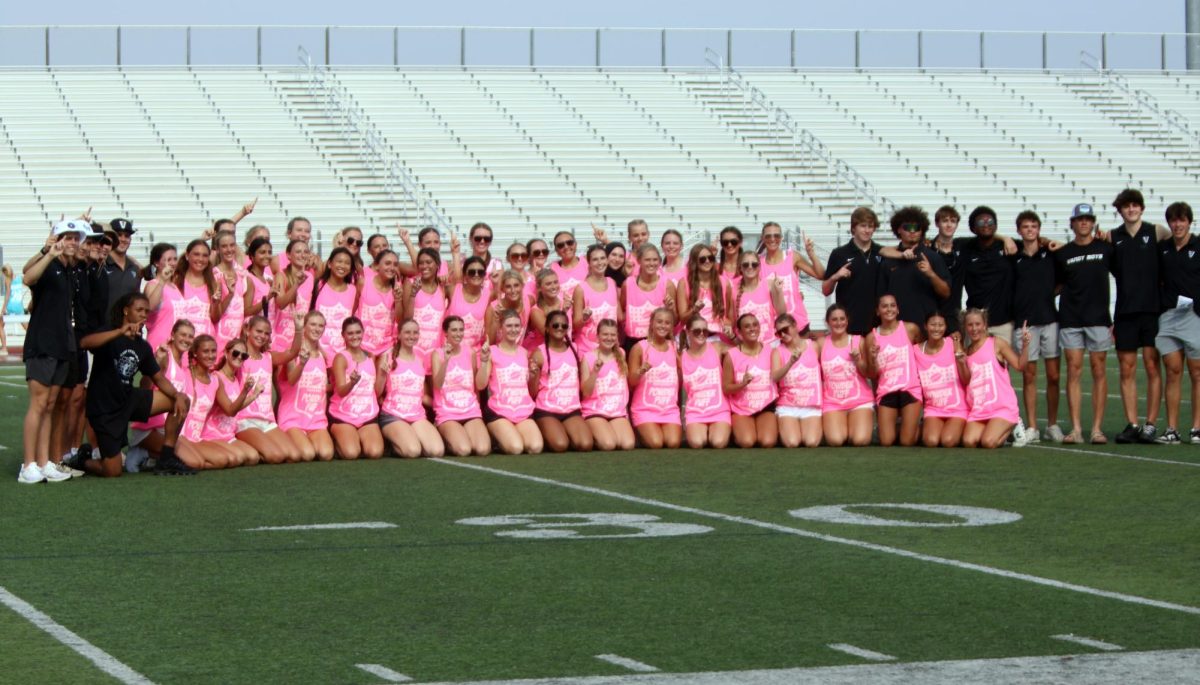 Senior girls pose for a picture after winning the Powder Puff game 21-7