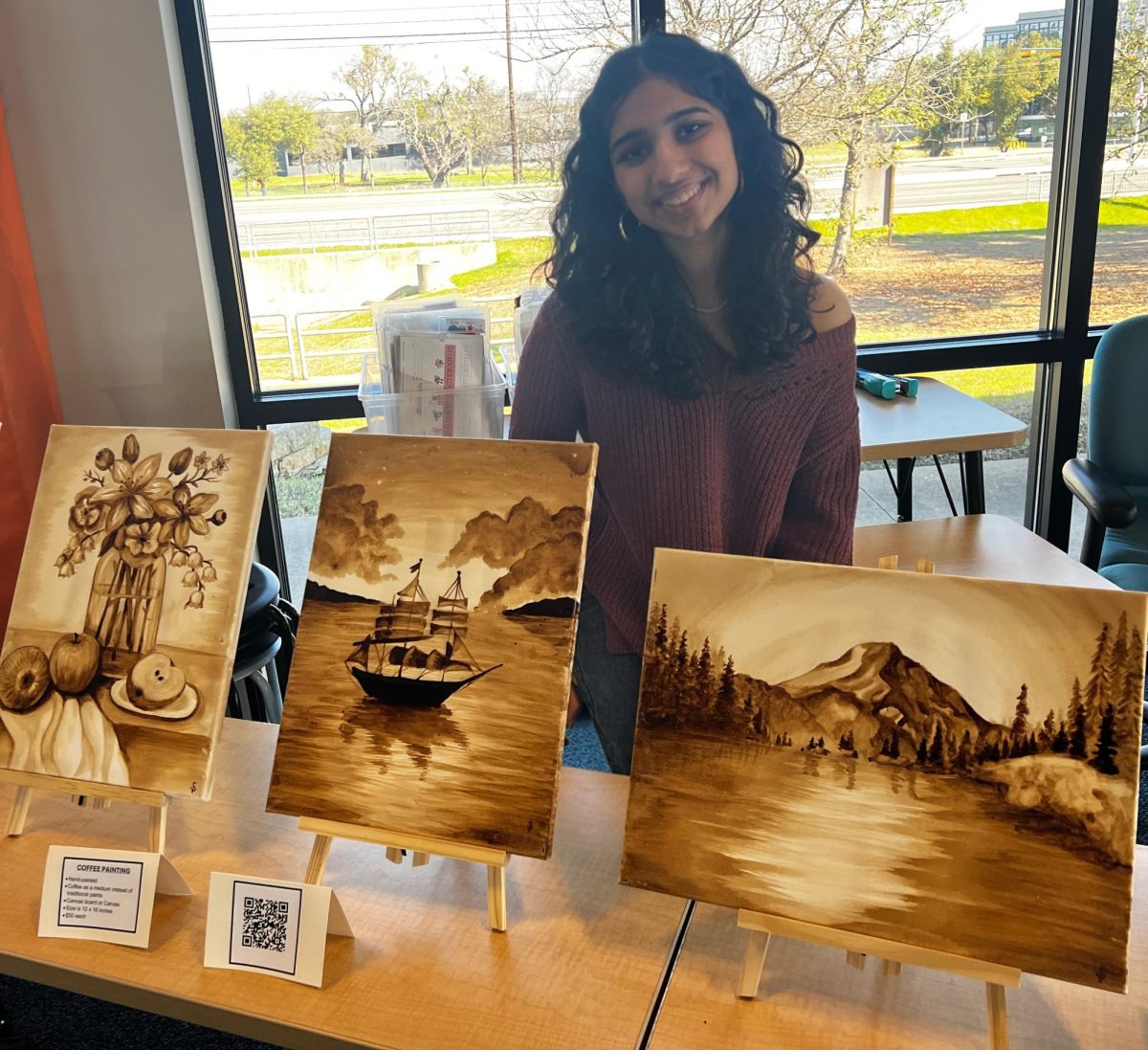 Junior Shreya Poladia stands with her art collection. Her art will later be sold in order to fundraise for her nonprofit work.