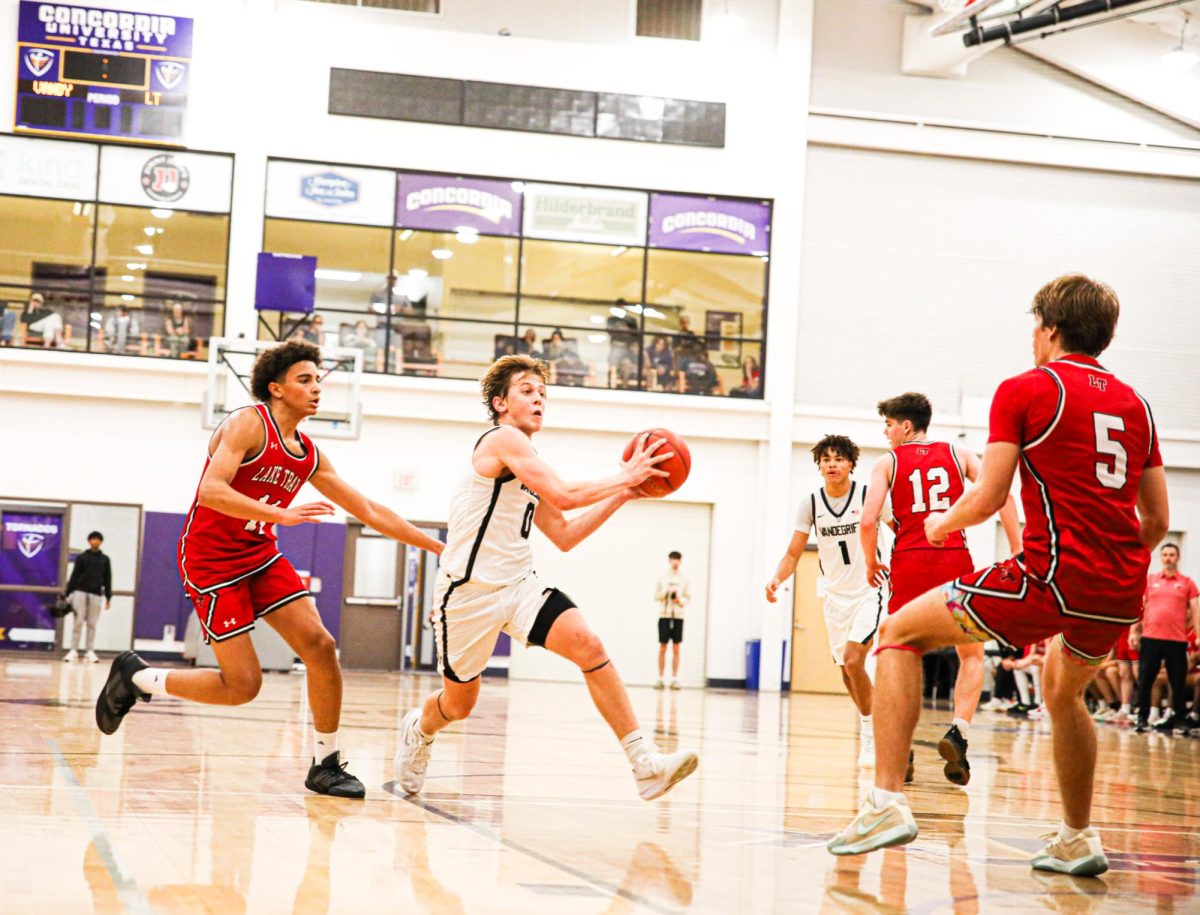 Senior Henry Defoore pump fakes while surrounded by defense.  