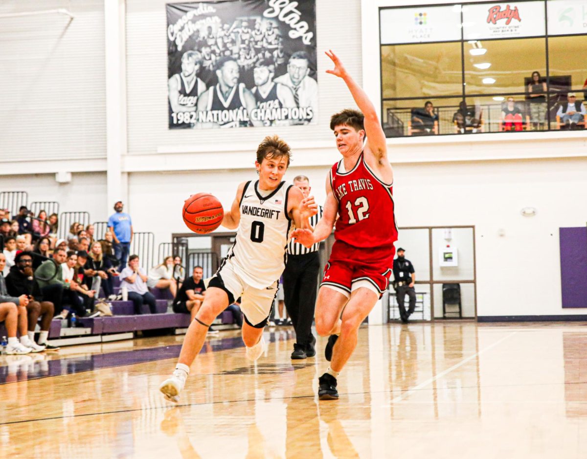 Senior Henry Defoore pushes the ball down the court. 