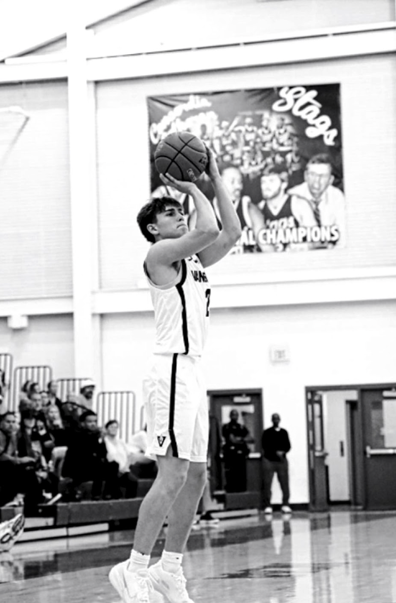 Junior Maddox Aronica shoots a three-pointer. 