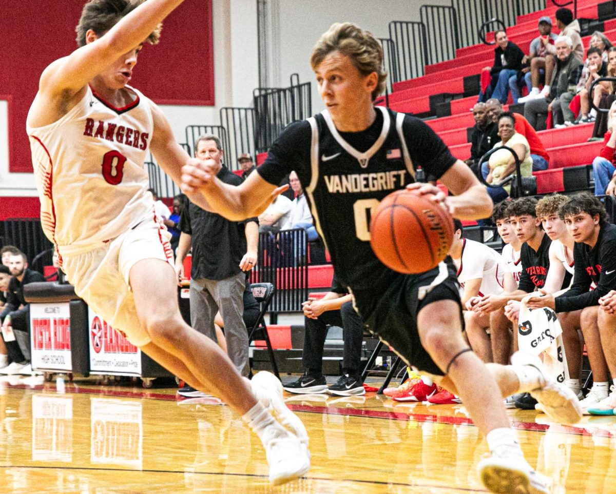 Senior Henry DeFoore dribbles down the baseline as he moves past the defense. 
