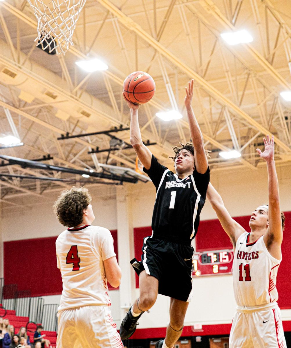 Junior Destin Herring shoots over defenders.