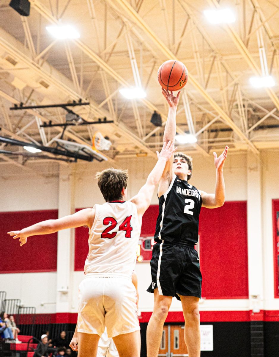 Junior Maddox Aronica shoots over defense. 