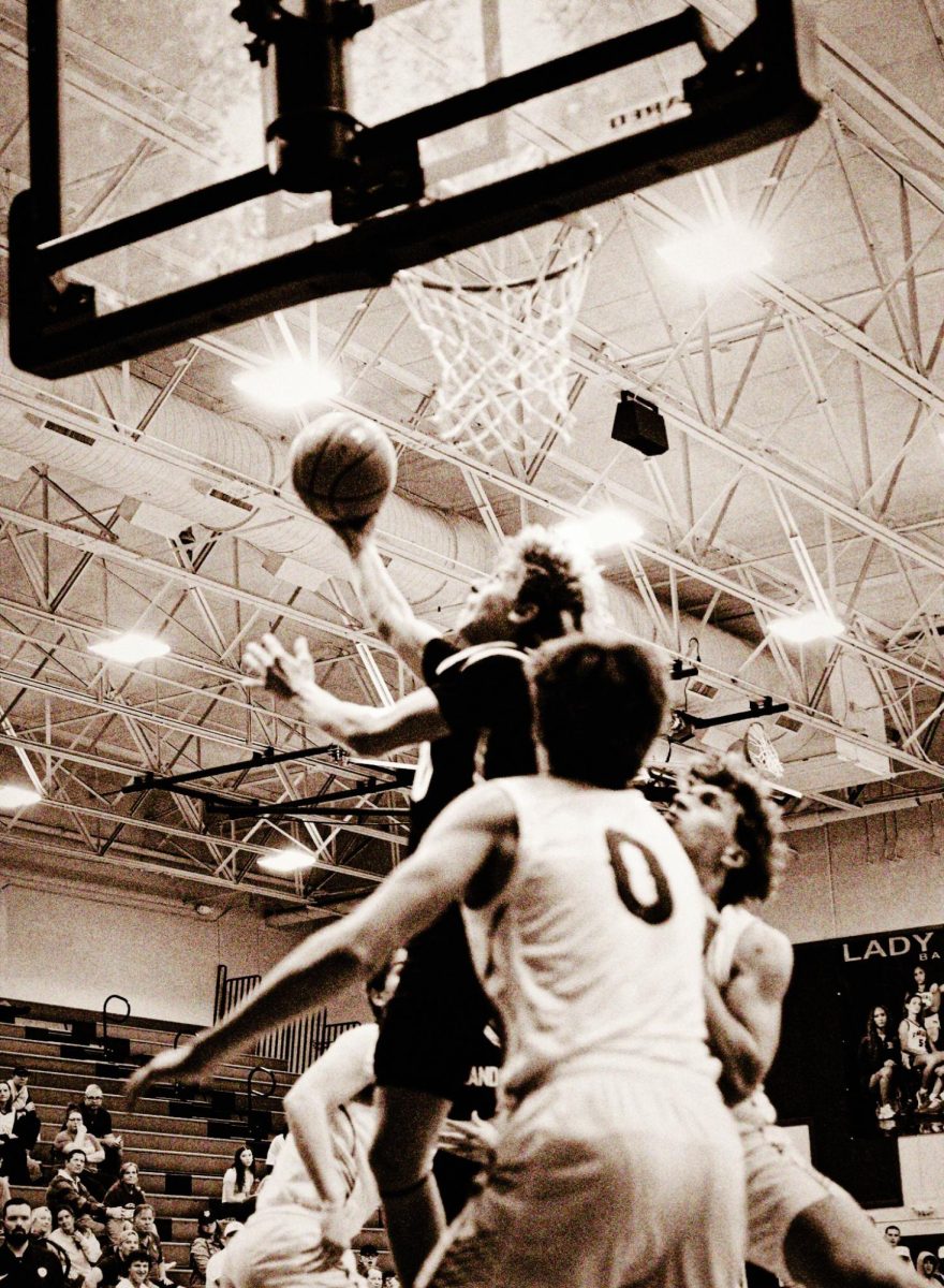 Senior Henry DeFoore rises over defenders for a reverse layup. 