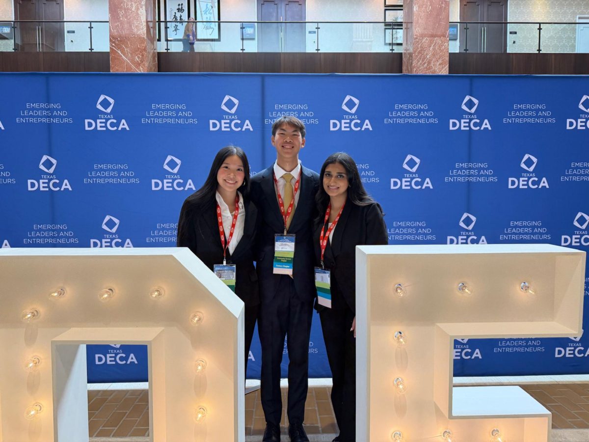 Seniors Isabella Yang and Caleb Luong, and junior Siri Krishna pose at the DECA state competition.