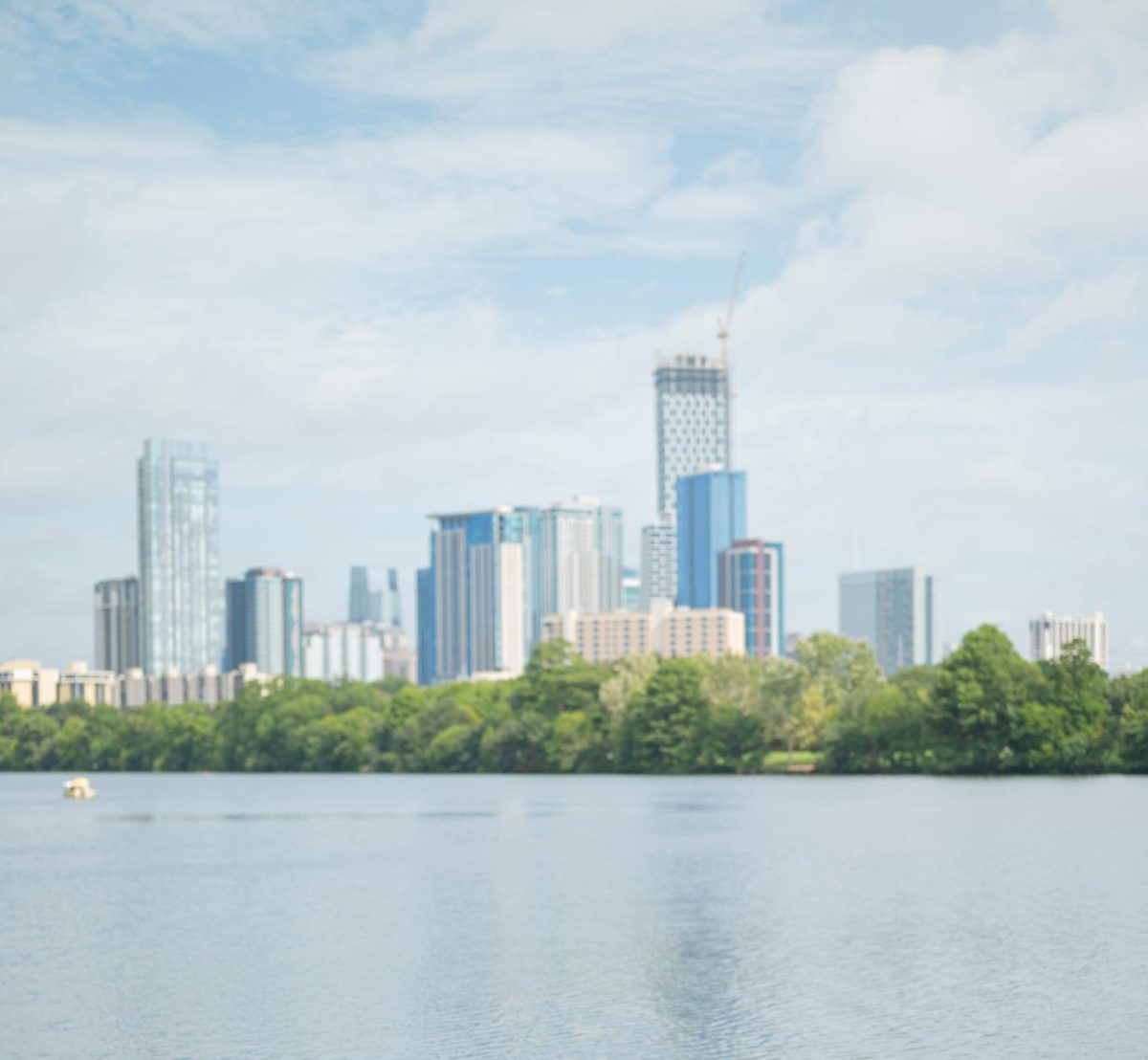The Austin downtown skyline rises over Lady Bird Lake.