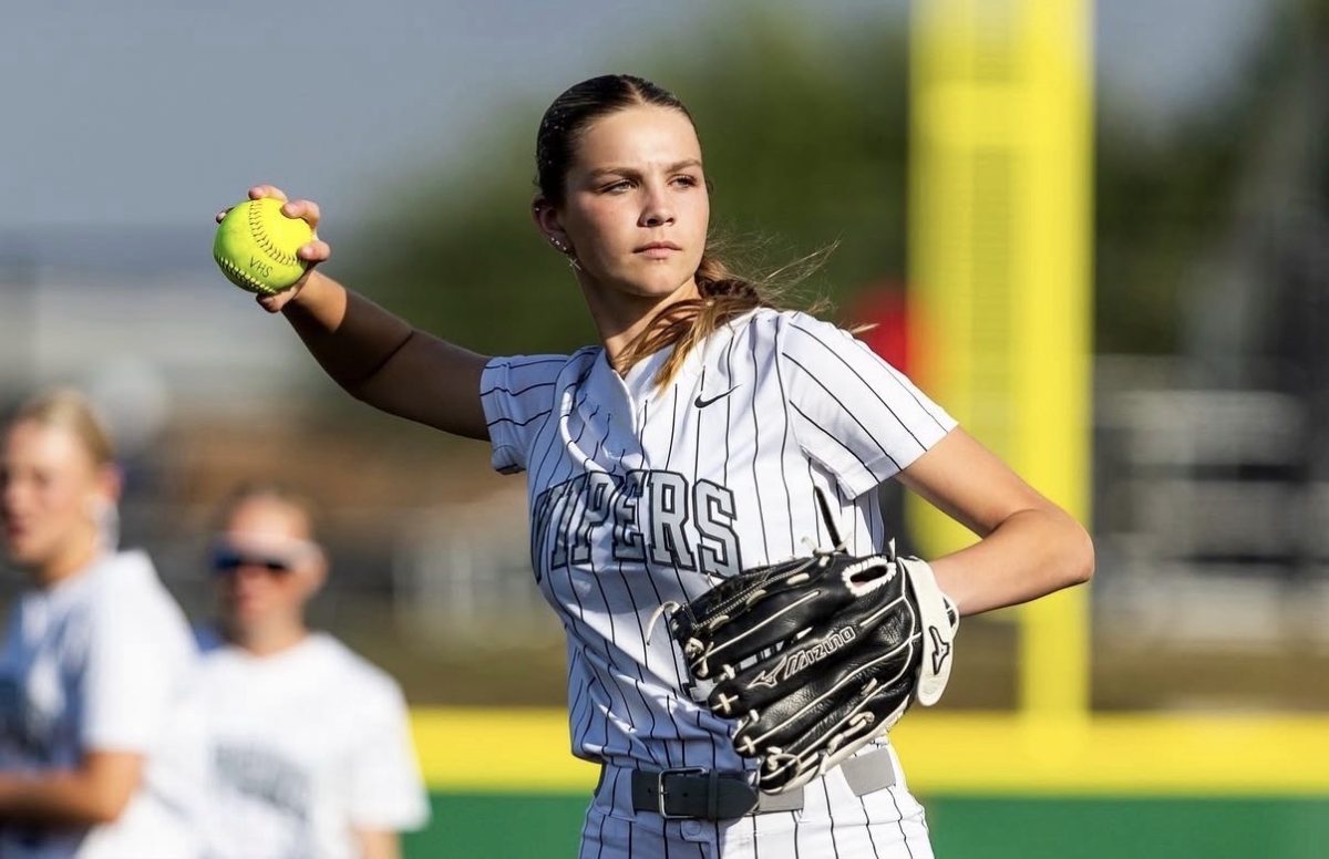 Freshman Madeline “McCrae” Moore stands on the pitcher's plate and swings backwards to throw overhand during a varsity girls softball game. Overall, the team is ranked eighth in 6A Region IV District 25. 